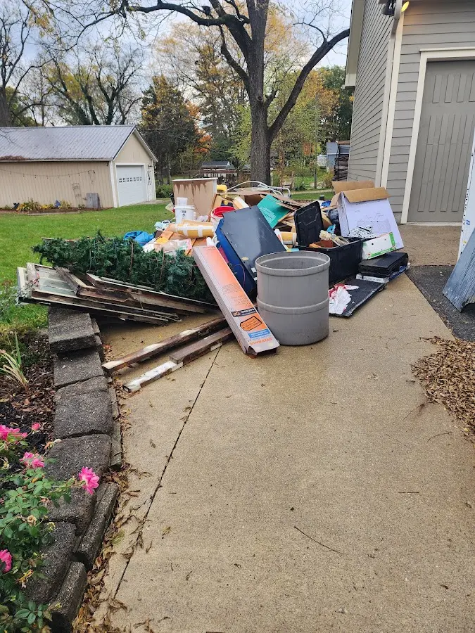 Dumpster being loaded with debris for Estate Cleanout Dumpster Rental in Clark